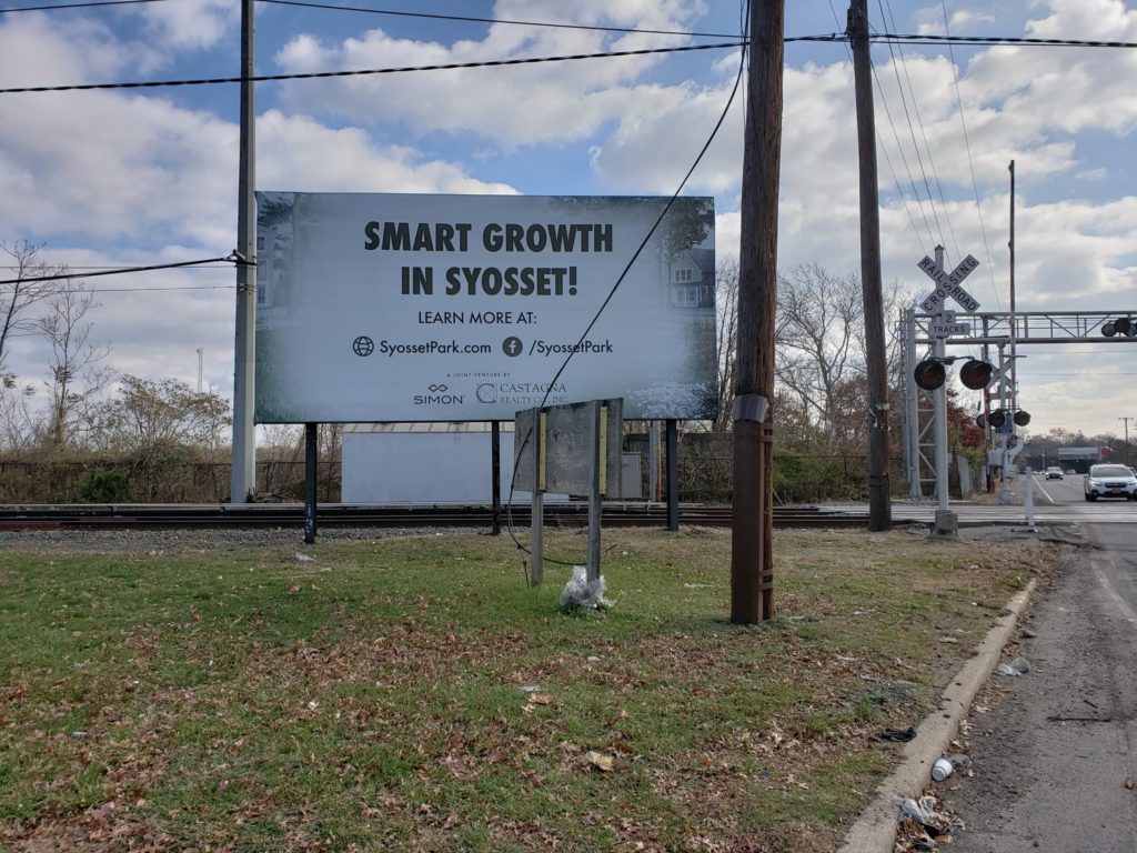 A billboard promoting development in Syosset